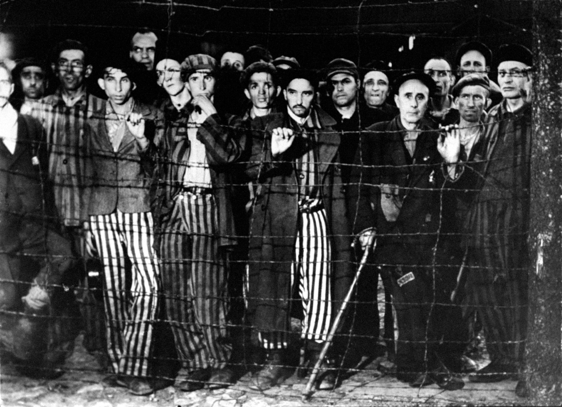 Buchenwald concentration camp prisoners stare in disbelief at their Allied liberators, April 1945.