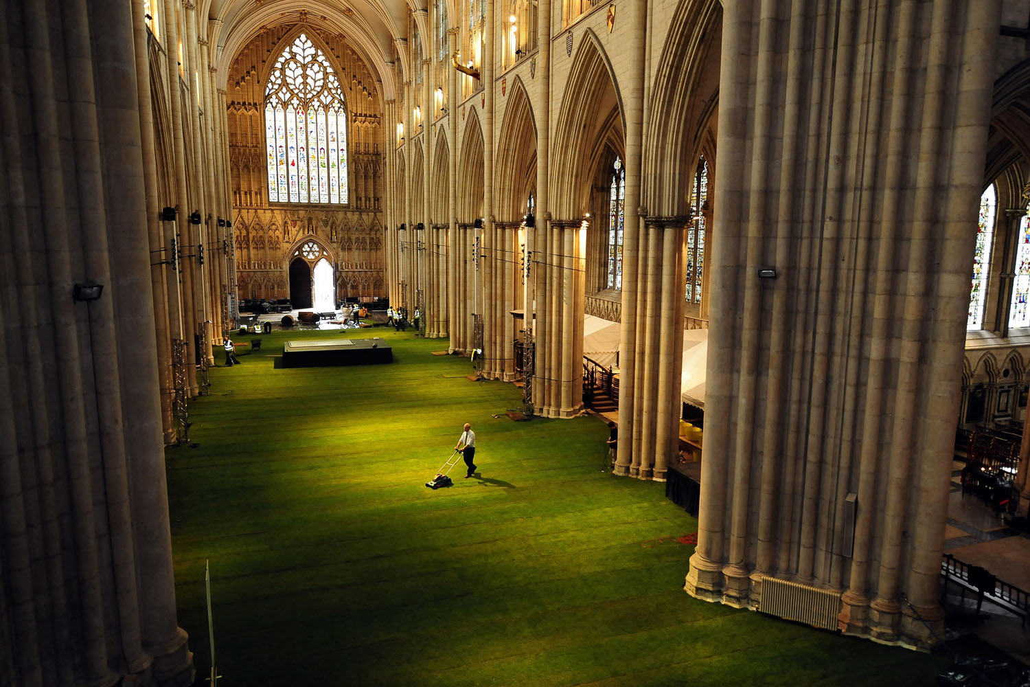 June 6, 2012. The Nave of York Minster is covered in 1500 square meters of real grass as the Minster is prepared for the York Minster Rose Dinner.