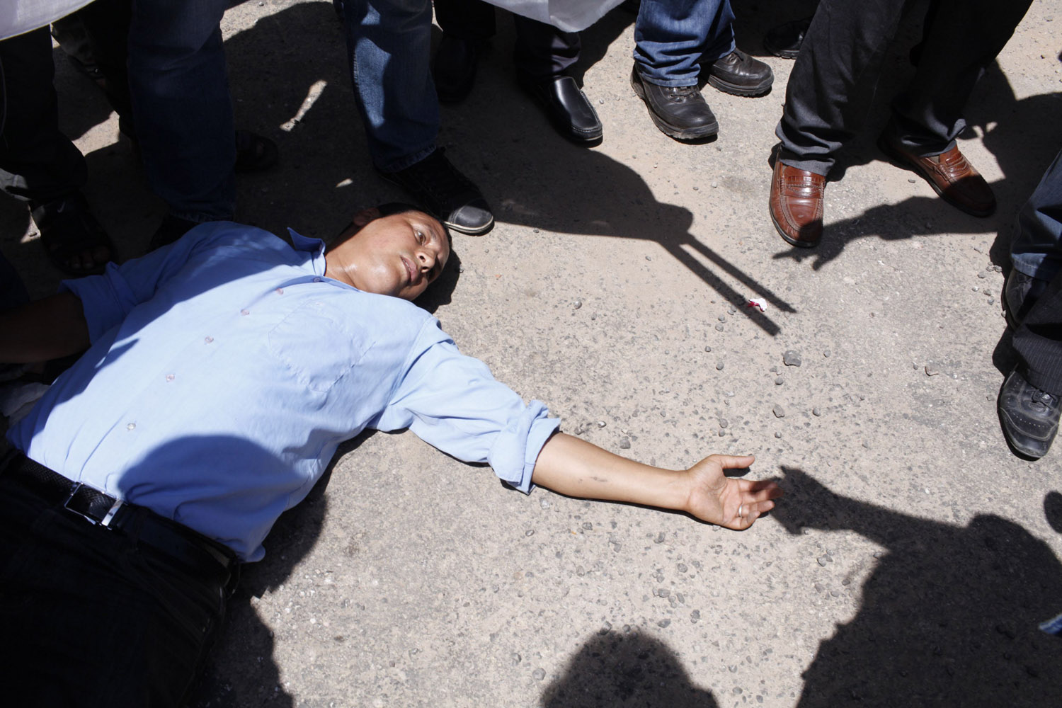 Demonstrators stand near a man during a protest by taxi drivers outside the police headquarters in Casablanca