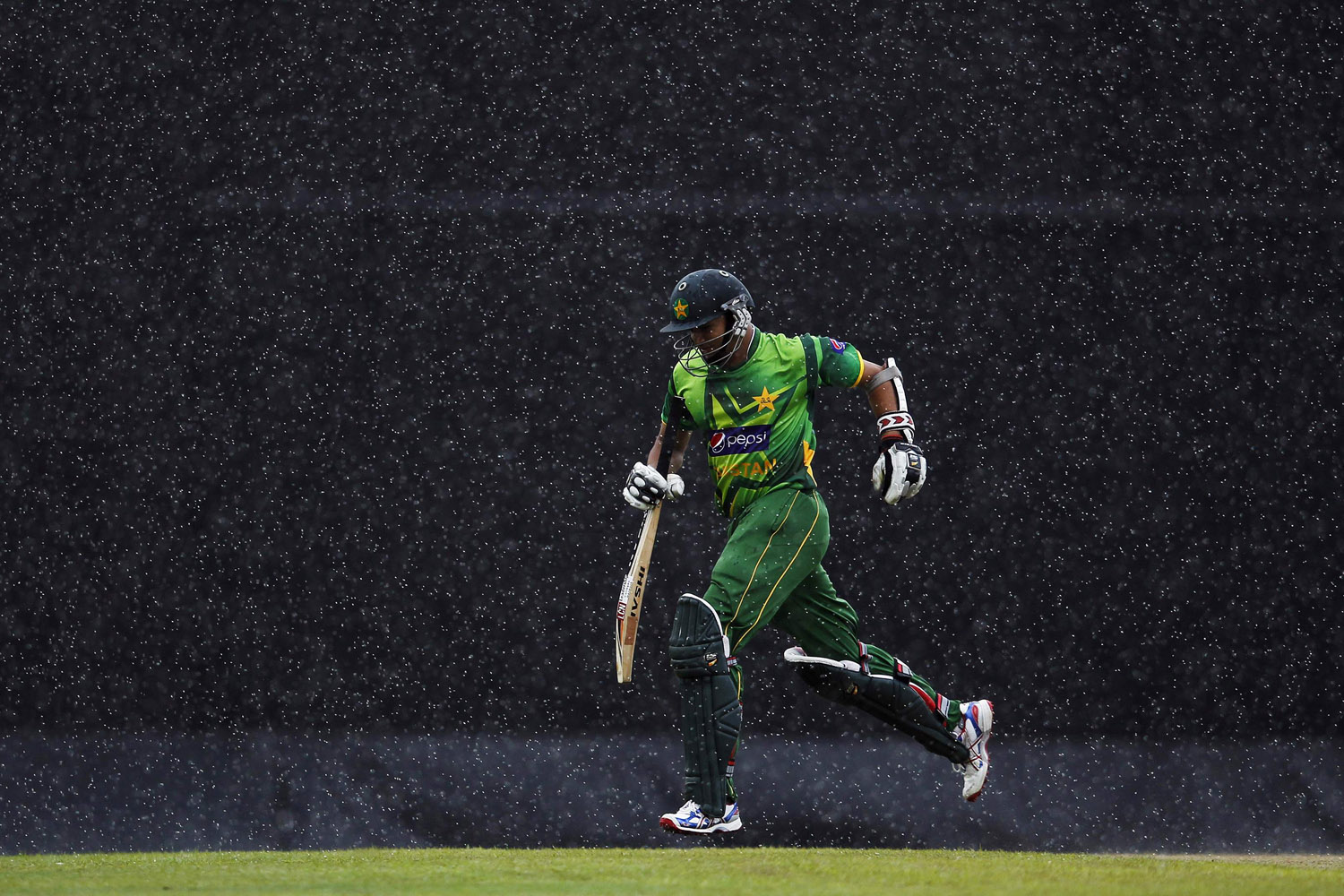 June 13, 2012. Pakistan's Azhar Ali runs back to pavilion as the match is stopped due the rain during their third One Day International (ODI) cricket match against Sri Lanka, in Colombo.