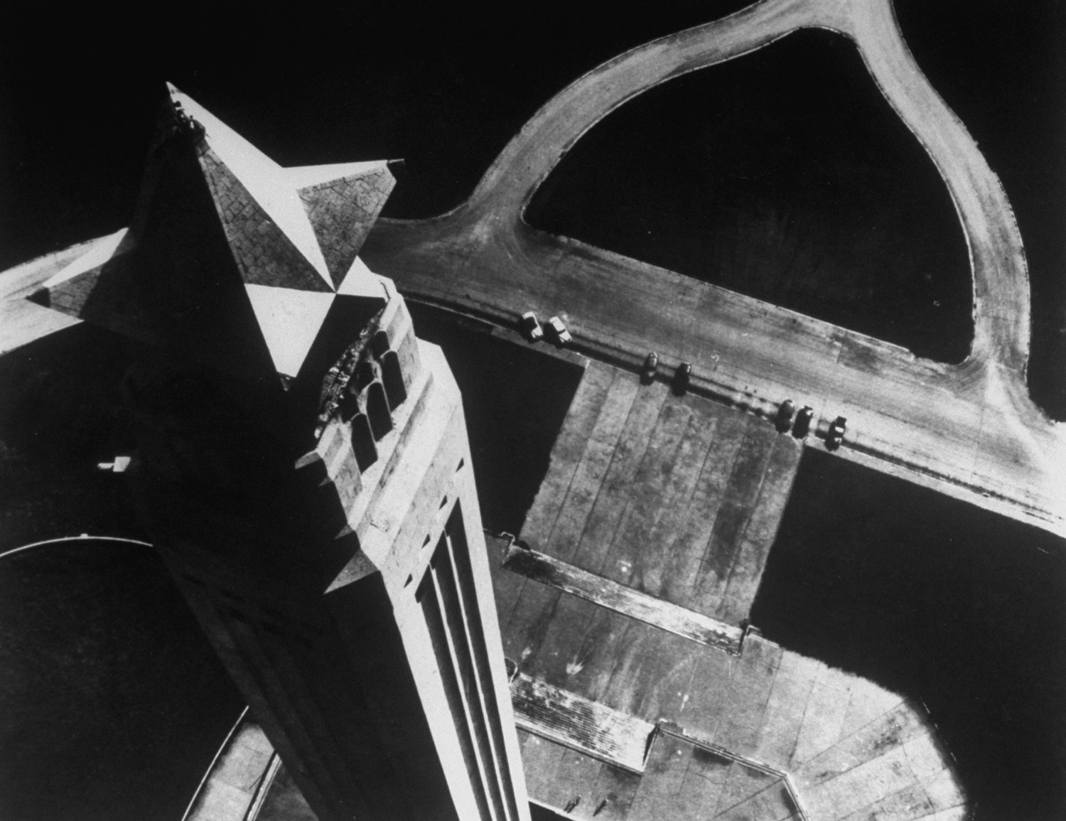 Caption from LIFE.  Over the Texas star on the San Jacinto Monument near Houston, helicopter-borne camera looks sharply down 570-foot shaft to steps and parking space below. Tower marks spot where Sam Houston defeated General Santa Anna in 1836.