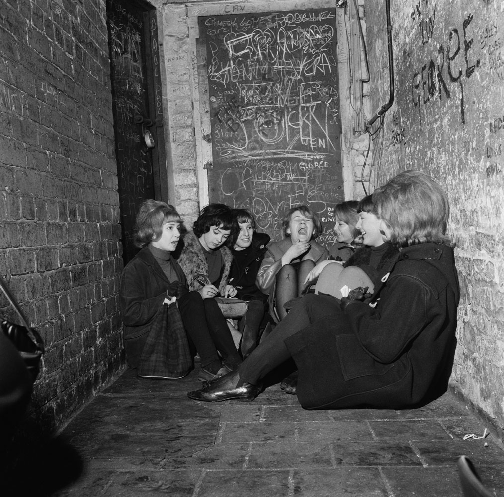 Beatles' fans sit in an alley way in Liverpool waiting for their heroes. April 24, 1963.