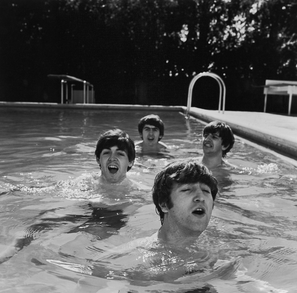 (L-R) Paul McCartney, George Harrison, John Lennon and Ringo Starr of The Beatles, taking a dip in a swimming pool. USA. February 1964.