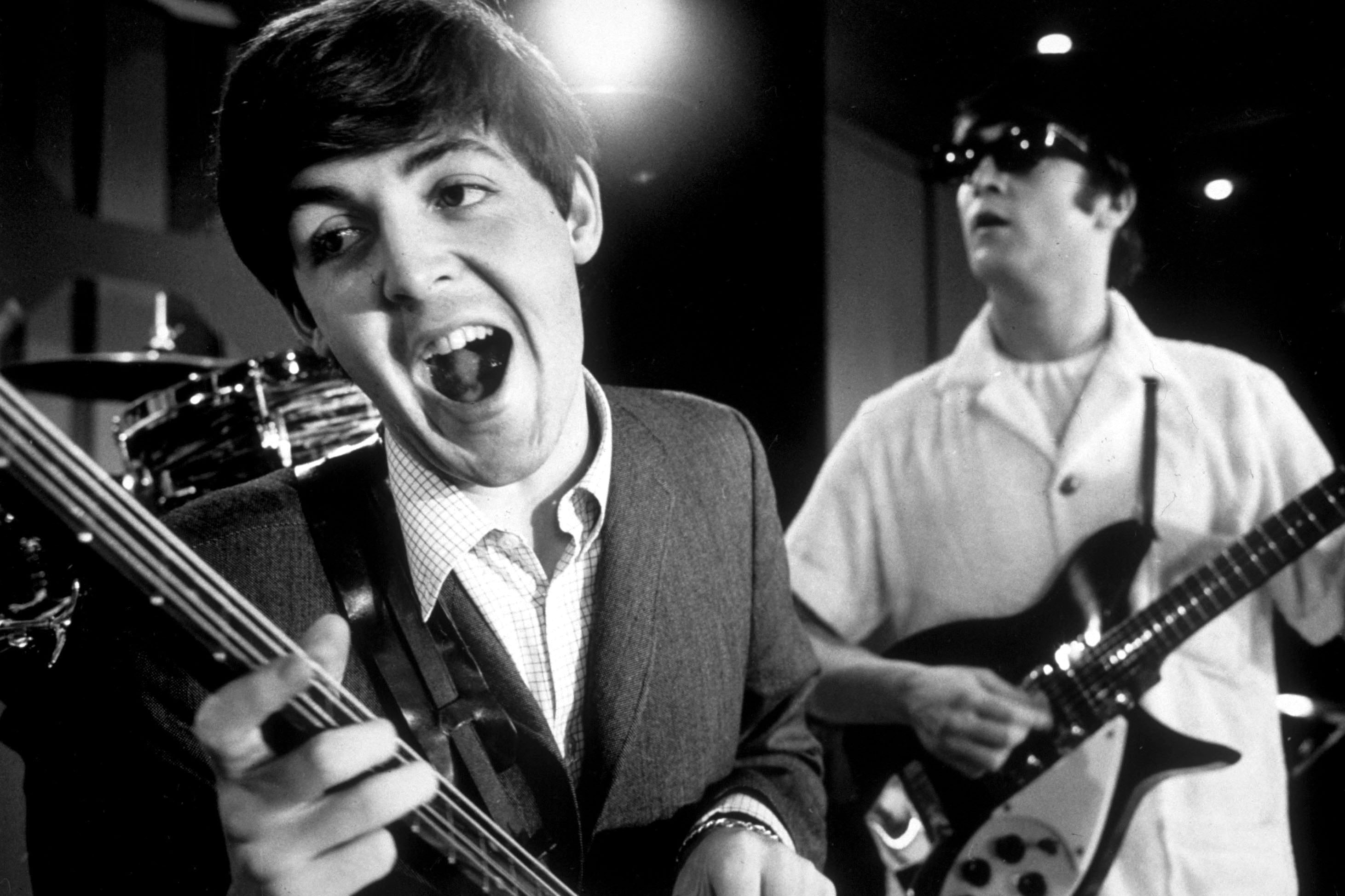 (L-R) Paul McCartney and John Lennon rehearsing on stage during the American tour of The Beatles, 1964.