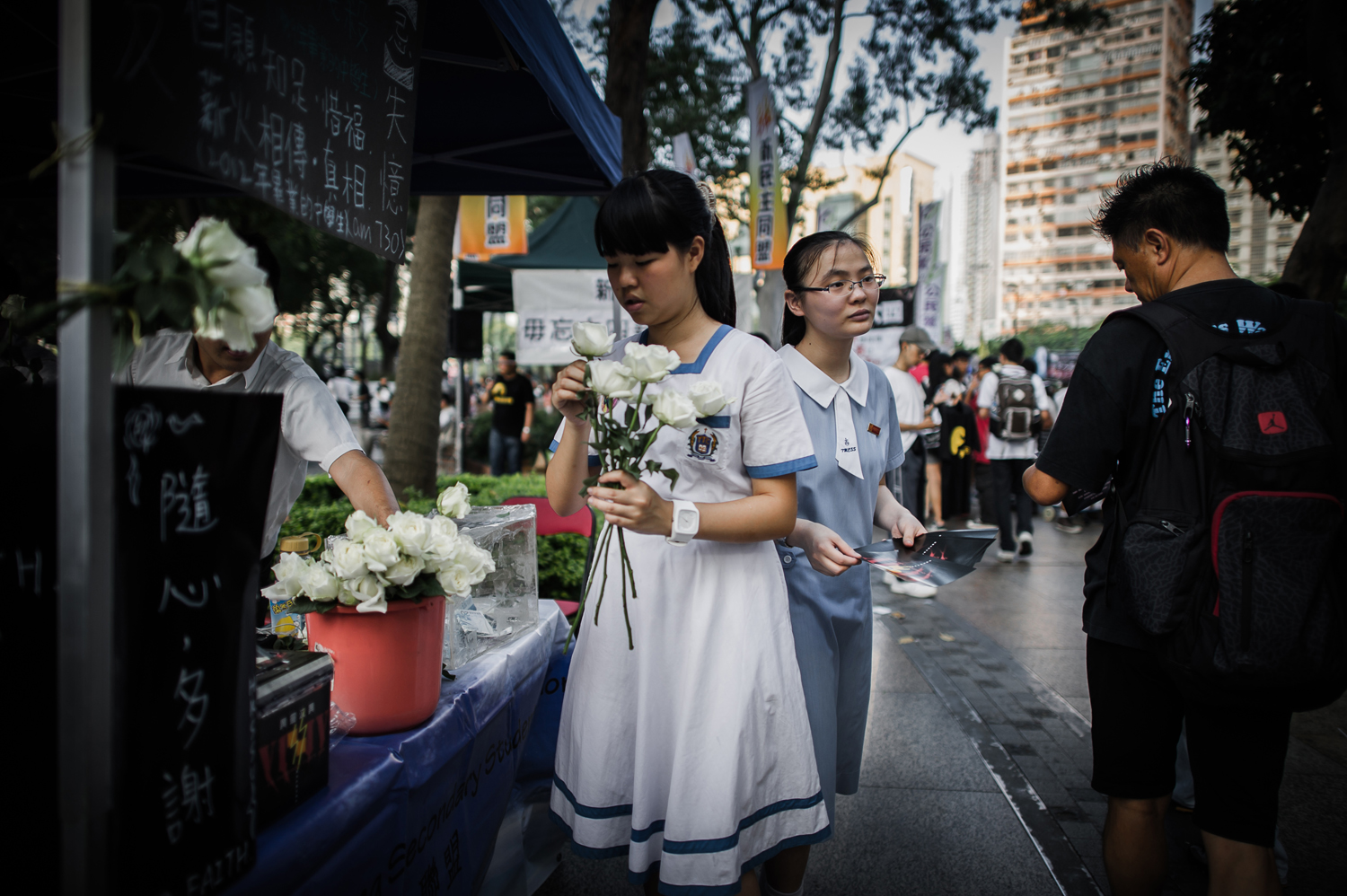 June 4, 2012. A schoolgirl offers roses while another distributes leaflets in Hong Kong ahead of a candlelight vigil held in the city to mark the anniversary of the crackdown on the pro-democracy movement in Beijing's Tiananmen Square in 1989.