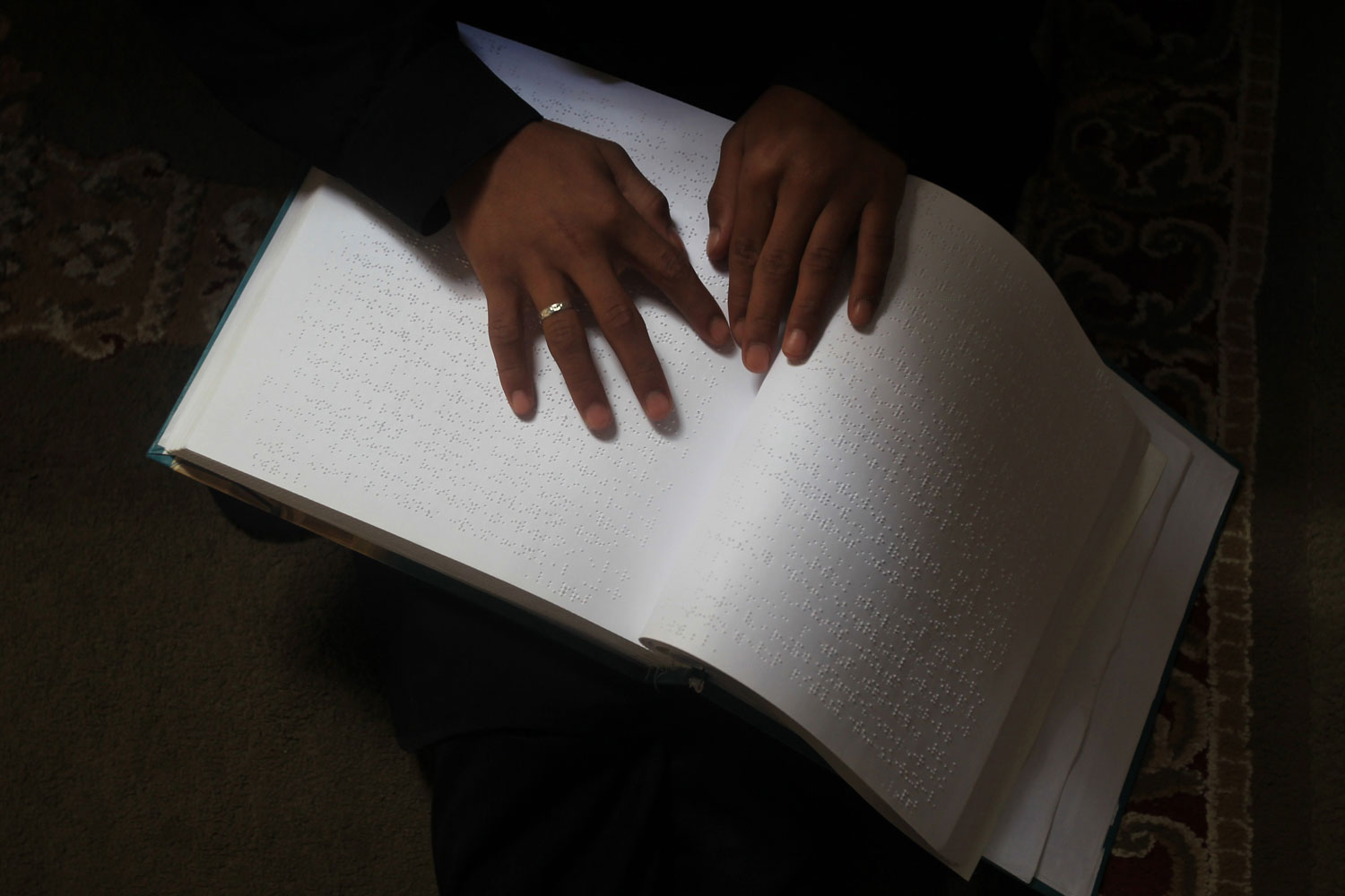 June 11, 2012. A Palestinian girl attends a class on how to read the Koran, Islam's holy book, in braille at a camp in a local mosque in Gaza City.