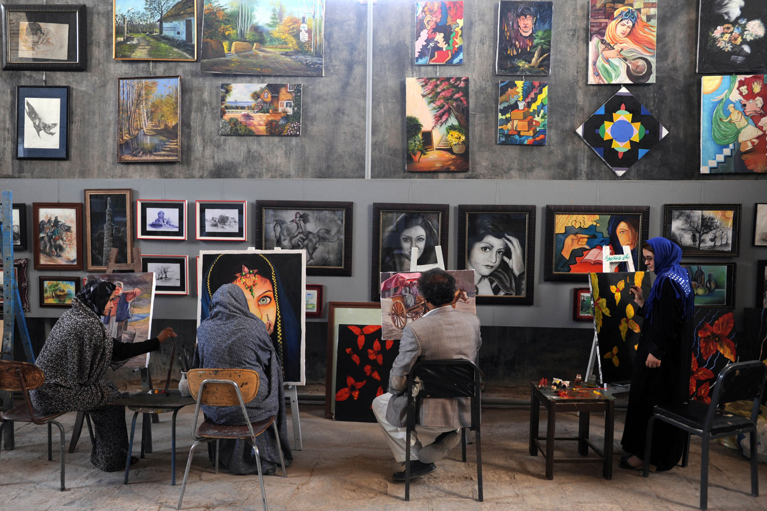 June 11, 2012. Afghan youths learn how to paint at the Behzad Art Gallery in Herat. The Taliban, ousted from power in a US-led invasion in 2001, banned girls from going to school and forbade people from painting and learn the arts.