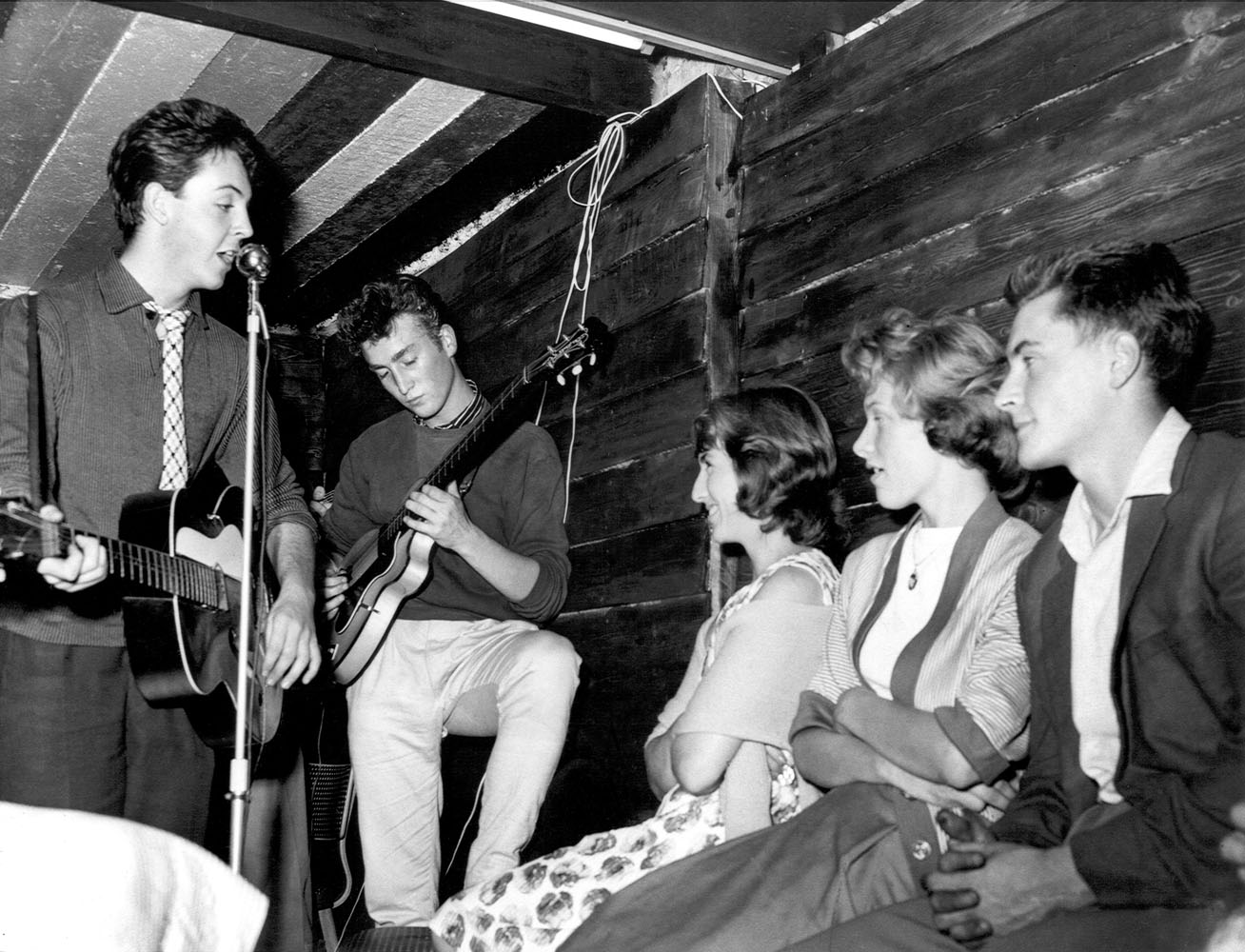 Paul McCartney and John Lennon members of the 'The Quarrymen' rock and roll band perform on stage at the Casbah Coffee House, Liverpool, England in 1959.