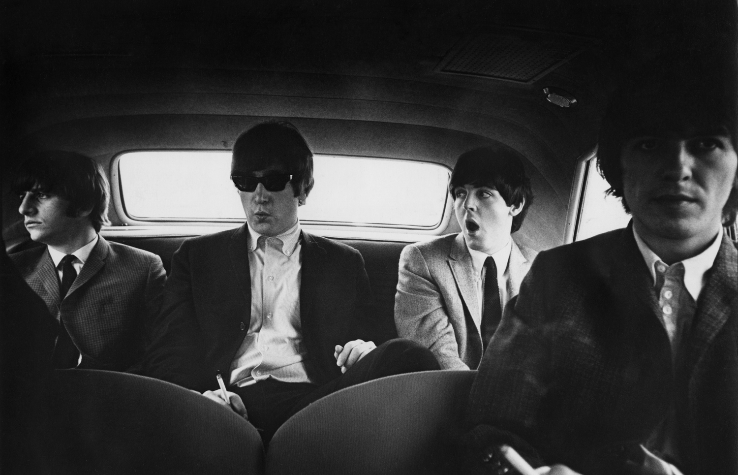 The Beatles inside a car in Denver, Colorado, 1964.