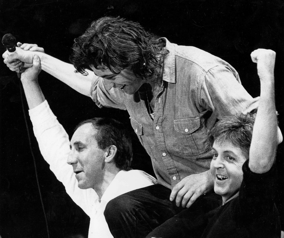 Pictured at the end of the Live Aid concert is Band Aid founder Bob Geldof who is hoisted shoulders high by Rock superstars Pete Townshend (left) of The Who and Paul McCartney, Wembley Stadium, London, 13th July 1985.