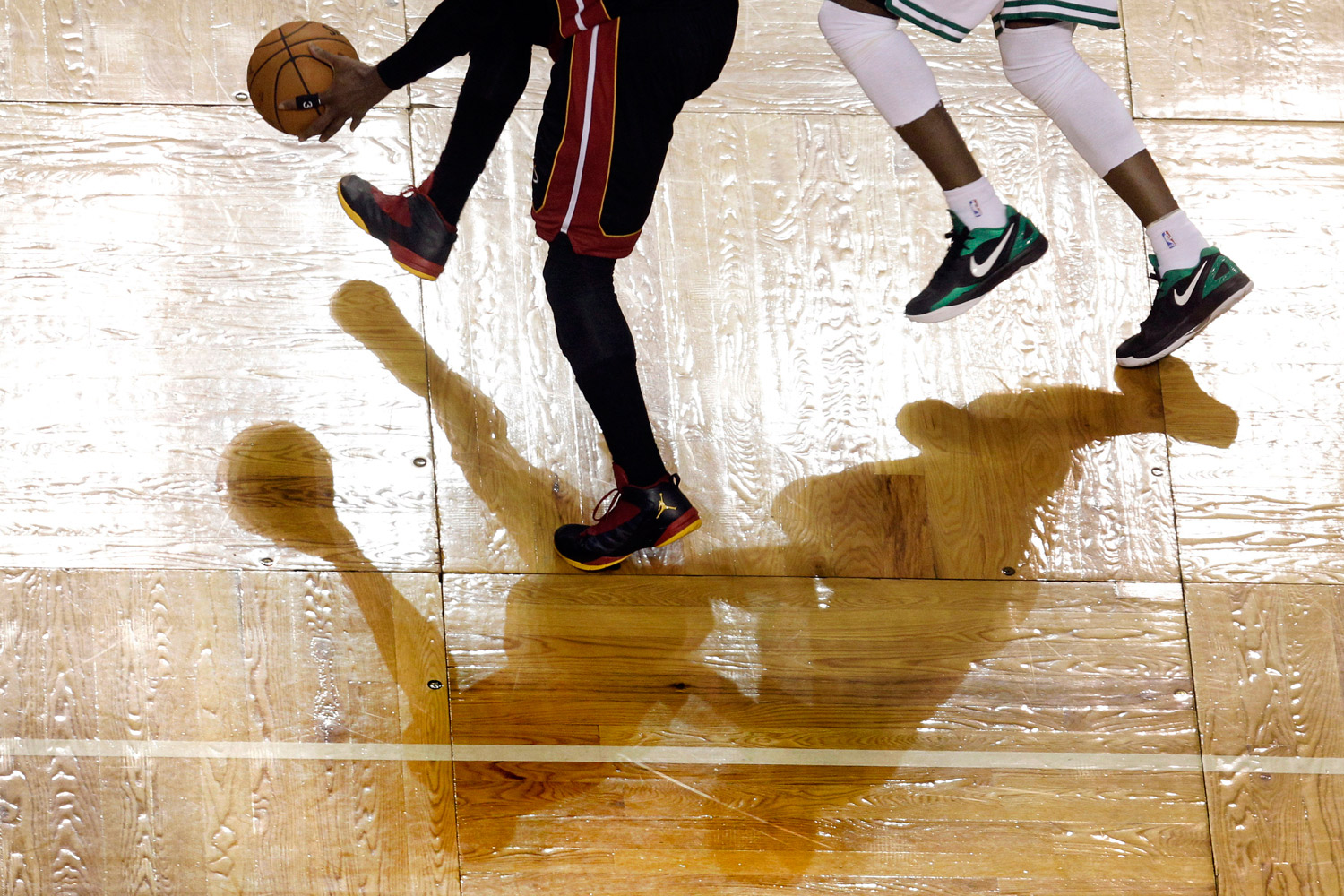 June 3, 2012. Miami Heat guard Dwyane Wade, left, drives to the basket against Boston Celtics forward Mickael Pietrus, right, during the fourth quarter of Game 4 in the NBA basketball Eastern Conference finals playoffs series in Boston.