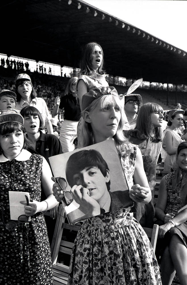 The Beatles in concert at the Vigorelli velodrome. A teenage girl holding a picture of Paul McCartney, Milan, Italy. June 24, 1965.