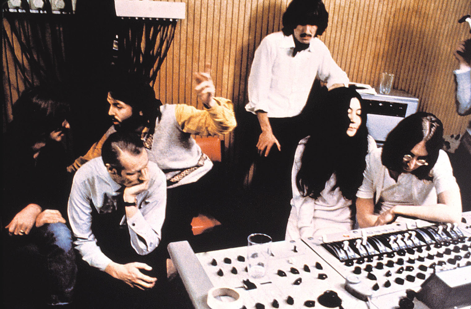 Still from film, Let It Be, 1970.  (l to r) Ringo Starr, George Martin, Paul McCartney, George Harrison, Yoko Ono, John Lennon.
