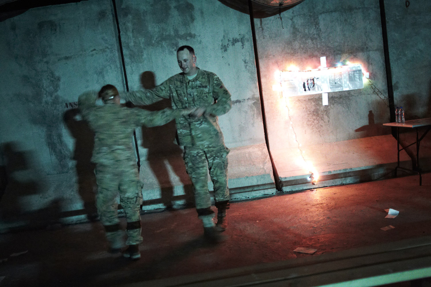 June 10, 2012. At Forward Operating Joycen, in Afghanistan's north eastern Kunar province, soldiers from Task Force Lethal Warrior dance during Karaoke night.