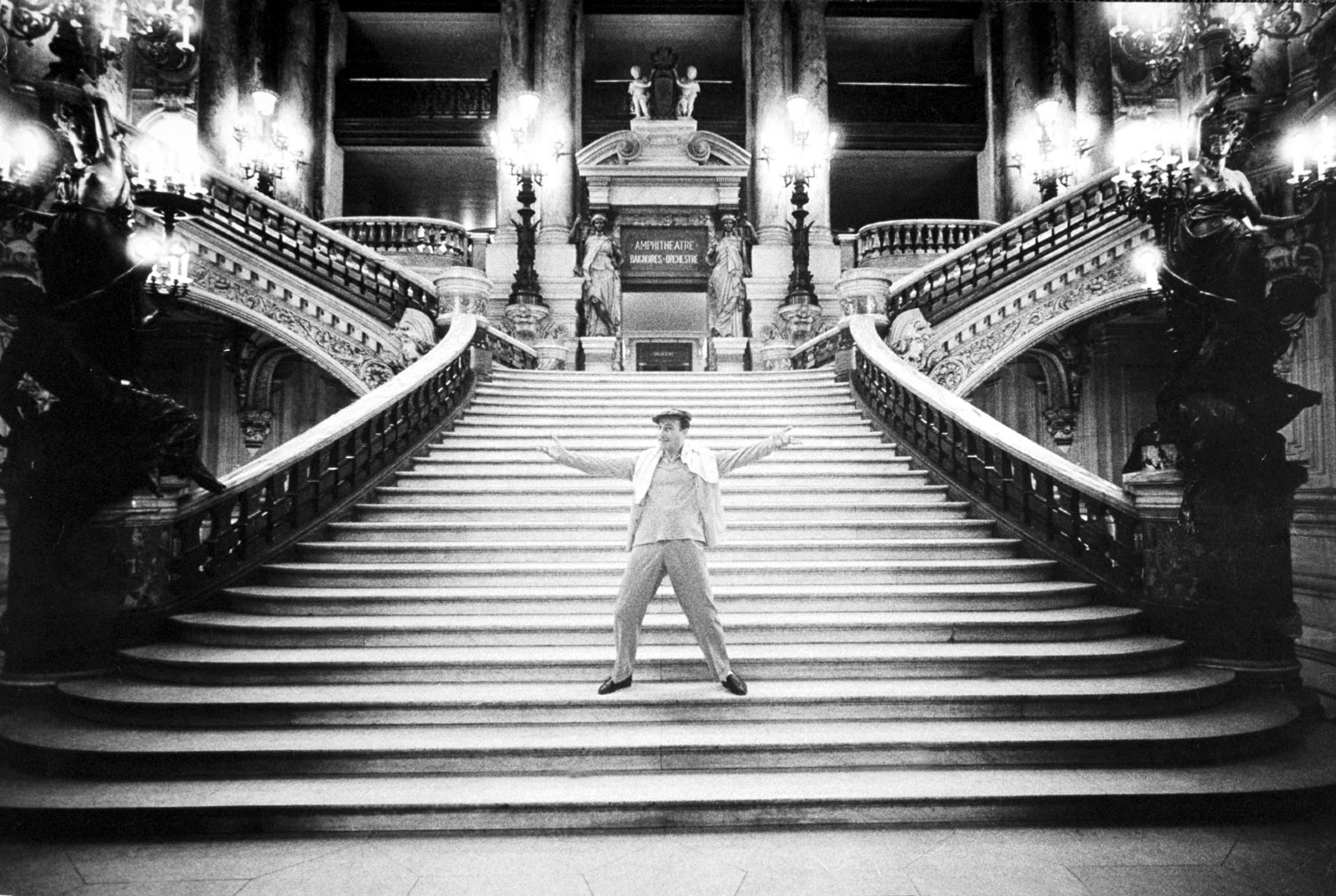 Gene Kelly on the steps of the grand staircase of the Paris Opera, 1960.