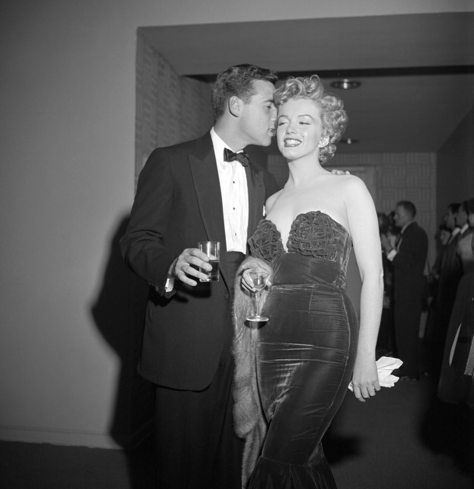 Marilyn Monroe (with an unidentified man) attends an awards night at the Club Del Mar, Santa Monica, Calif., 1952.