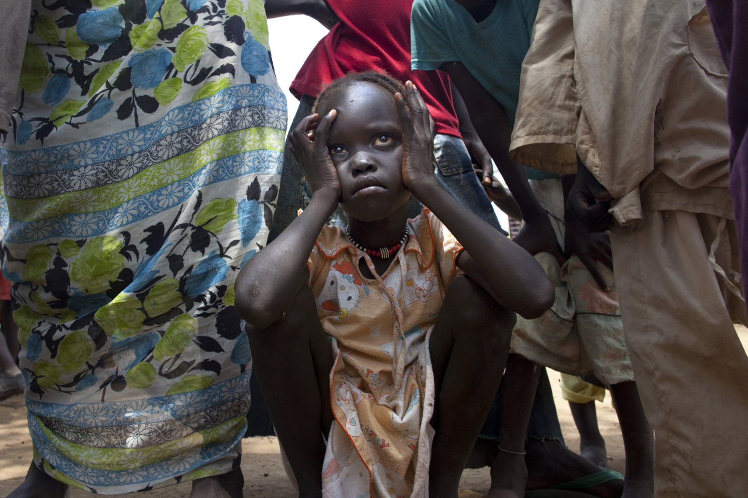 July 16, 2012. A sick Sudanese girl waits for transport to the MSF field hospital in the Jamam refugee camp, South Sudan.