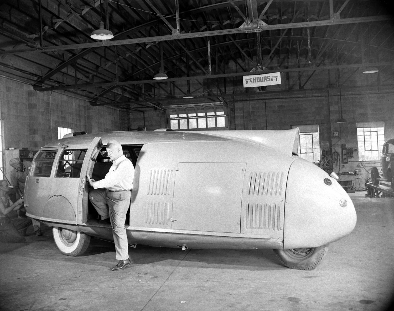 Buckminster Fuller and his three-wheeled Dymaxion car, 1945.