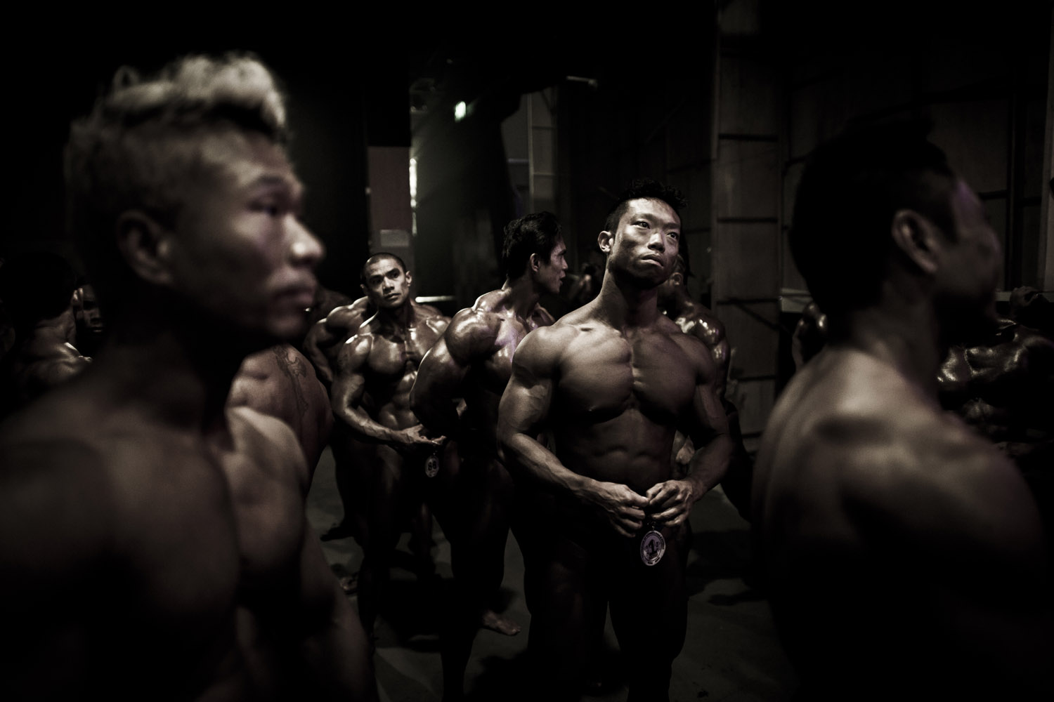 July 15, 2012. Competitors wait backstage during the 2012 International Bodybuilding and Fitness Invitation Championship in Hong Kong.