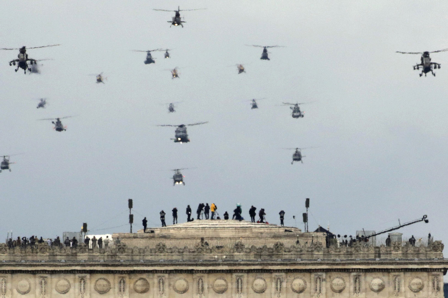 July 14, 2012. A formation of military helicopters fly over the Arc de Triomphe during the traditional Bastille Day military parade in Paris.