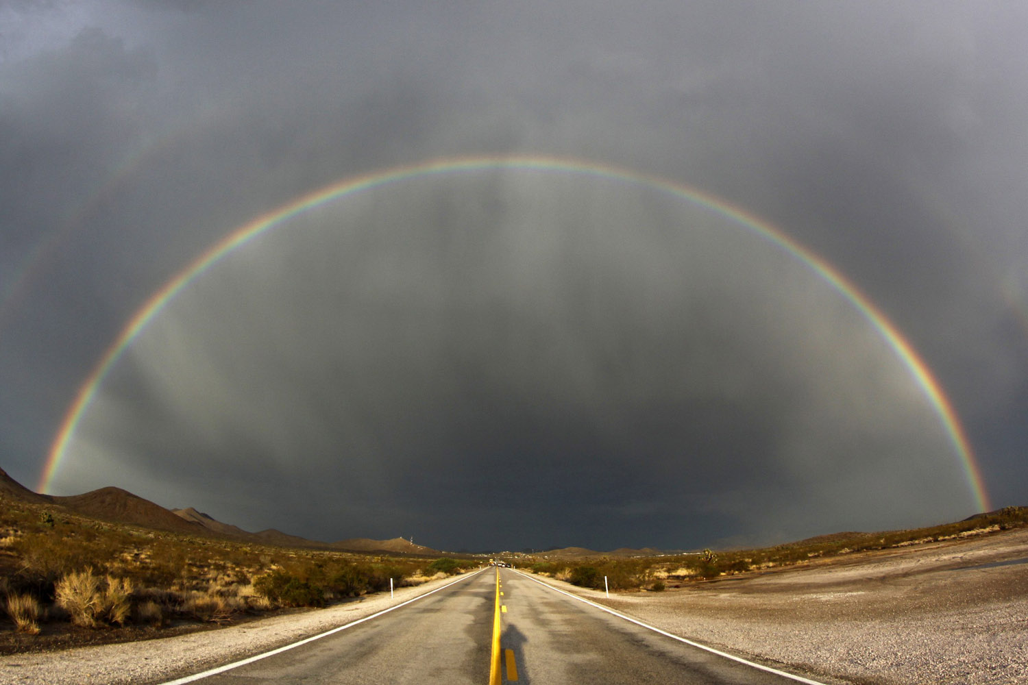 July 13, 2012. A double rainbow appears over Nipton Road in Searchlight, Nev. after heavy storms.