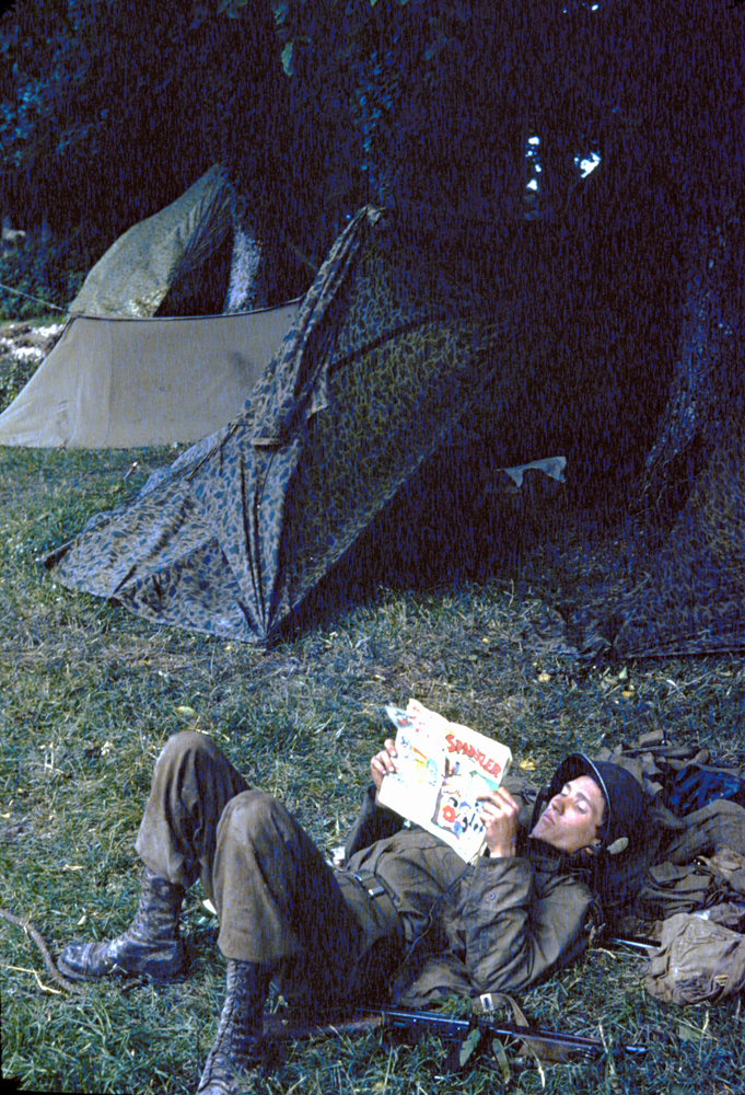 Private Ernest Dandou reads a comic book at paratrooper camp, Georgia, 1944.