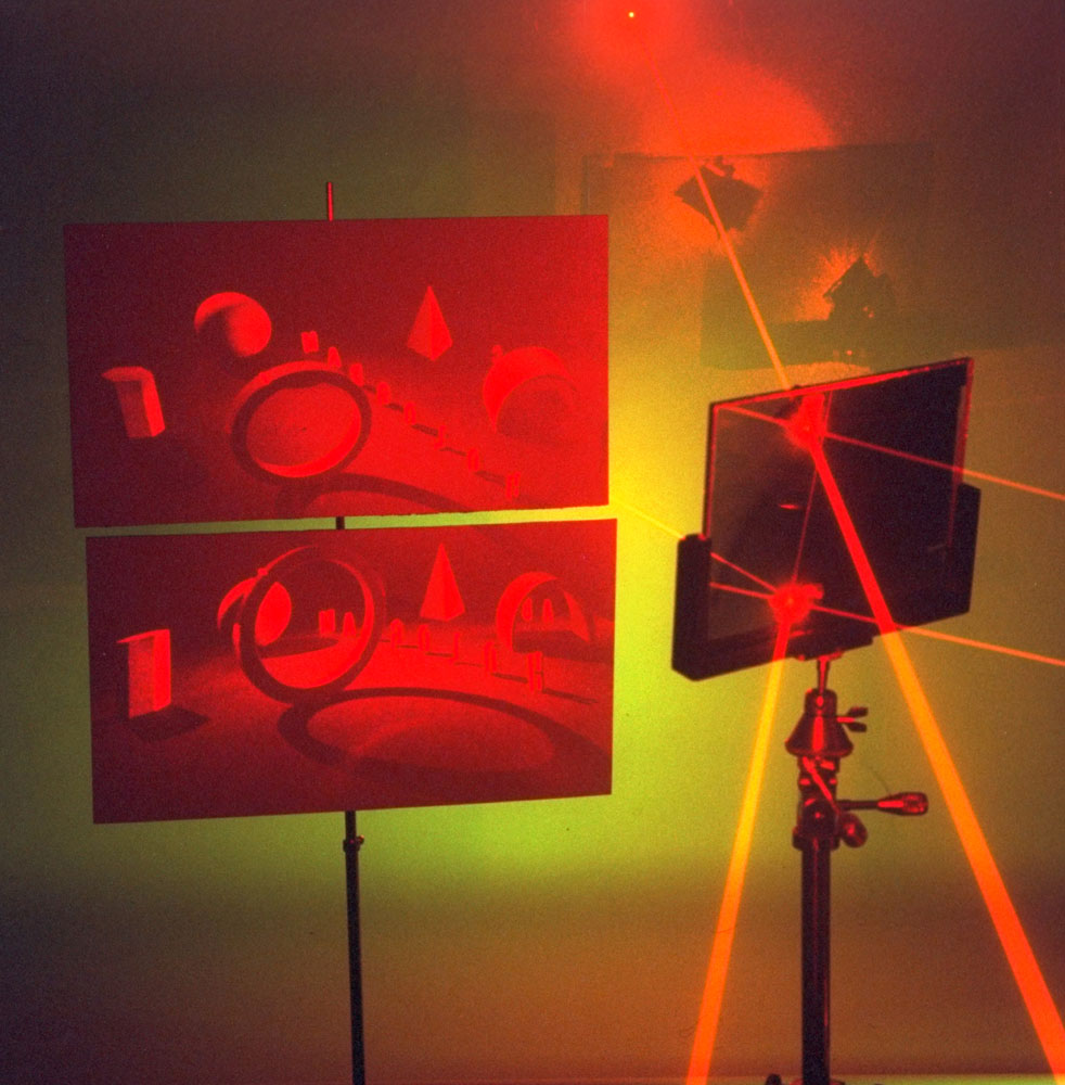 Two perspectives of a single hologram, projected on screens when a laser passes through the hologram at different places, 1966. Hologram made by Juris Upatnieks.