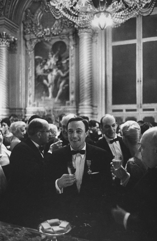 Gene Kelly enjoys himself at a party following the triumphant premiere of his ballet at the Paris Opera, 1960.