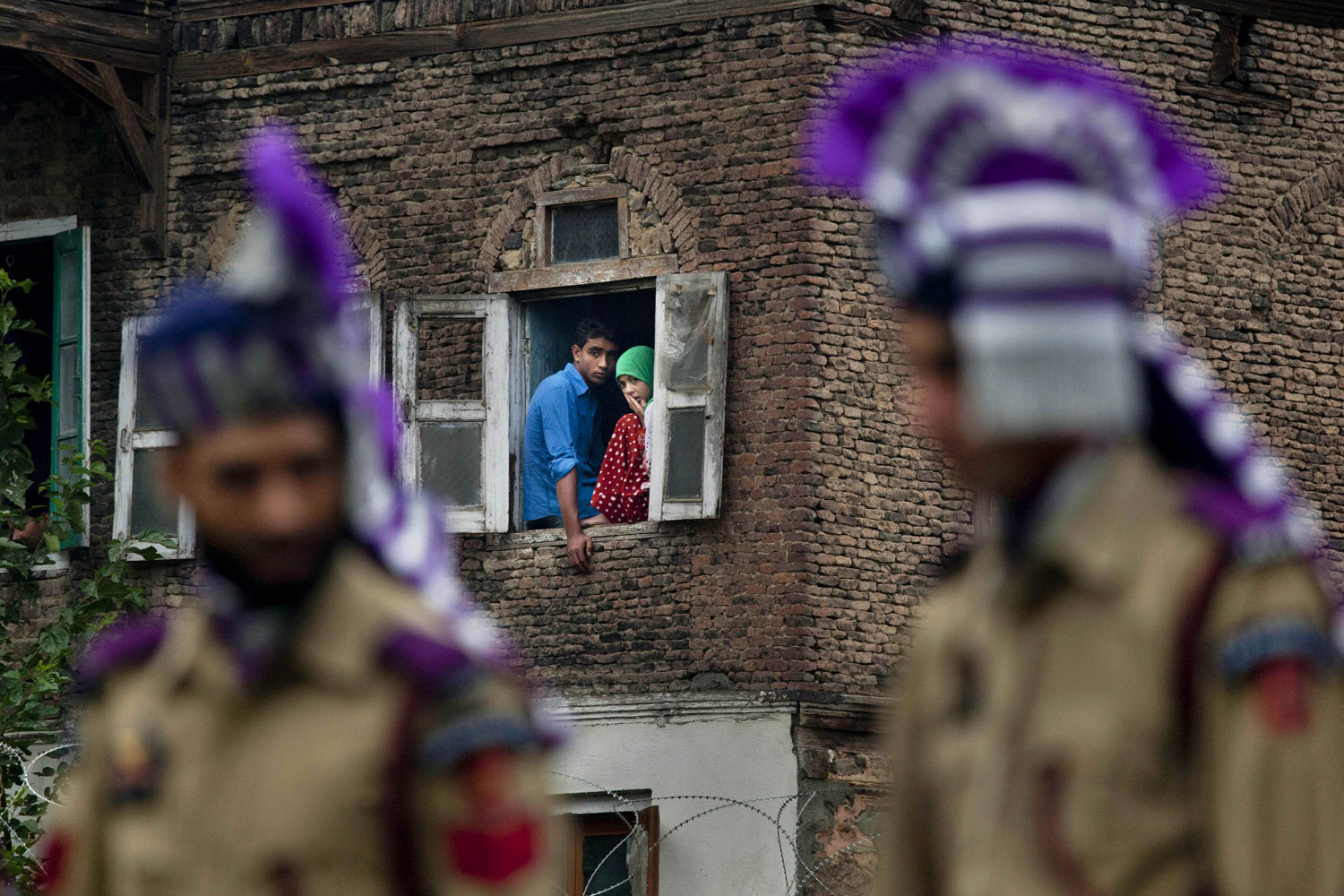 July 13, 2012. Kashmiri Muslims watch a Martyrs' Day outside Martyr's Graveyard in Srinagar, India.