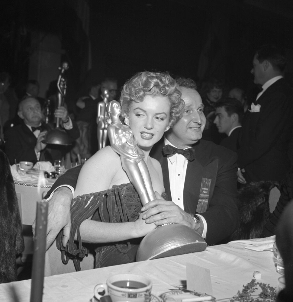 Marilyn Monroe holds her Henrietta Award during ceremony at the Club Del Mar, Santa Monica, Calif., 1952.