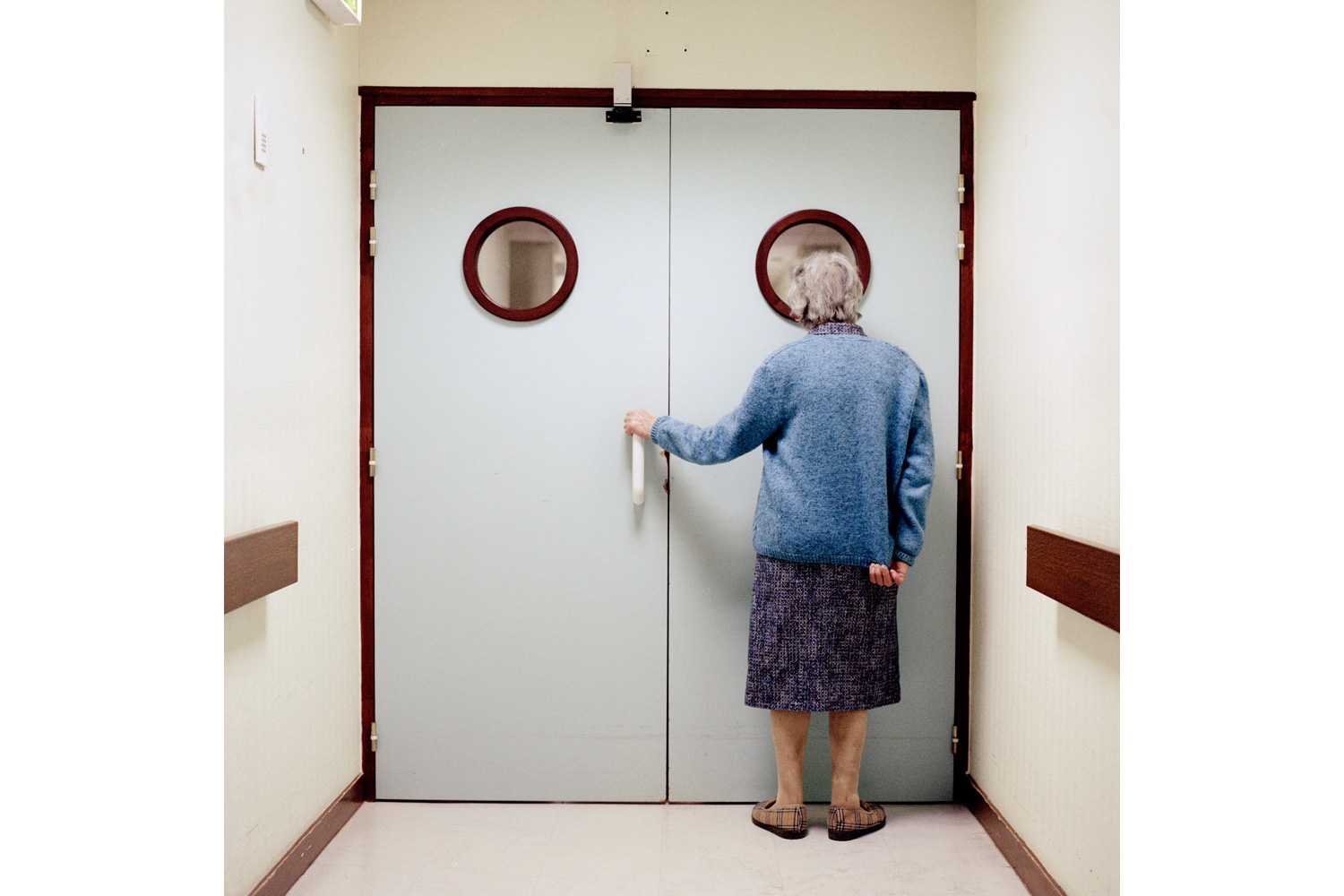 A resident stands in front of the ward’s locked exit door