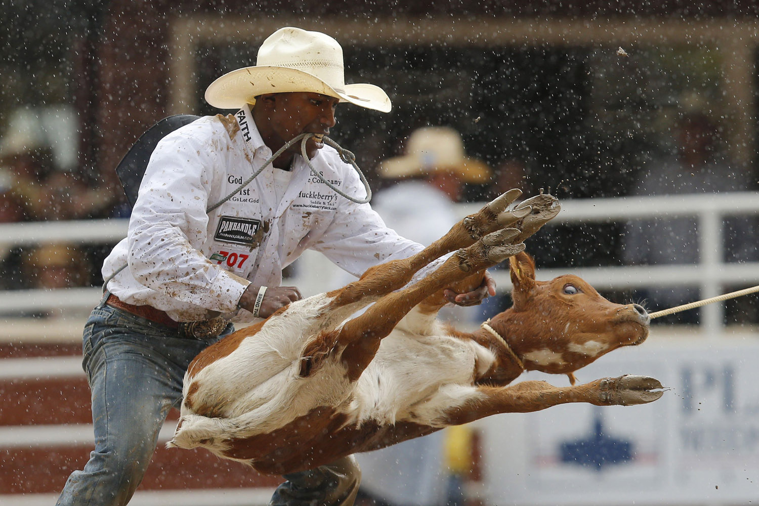 July 15, 2012. Cory Solomon of Prairieviw, Texas flips a steer on his way to winning the tie-down roping event and $100,000 during the finals at the 100th anniversary of the Calgary Stampede Rodeo in Calgary, Alberta.