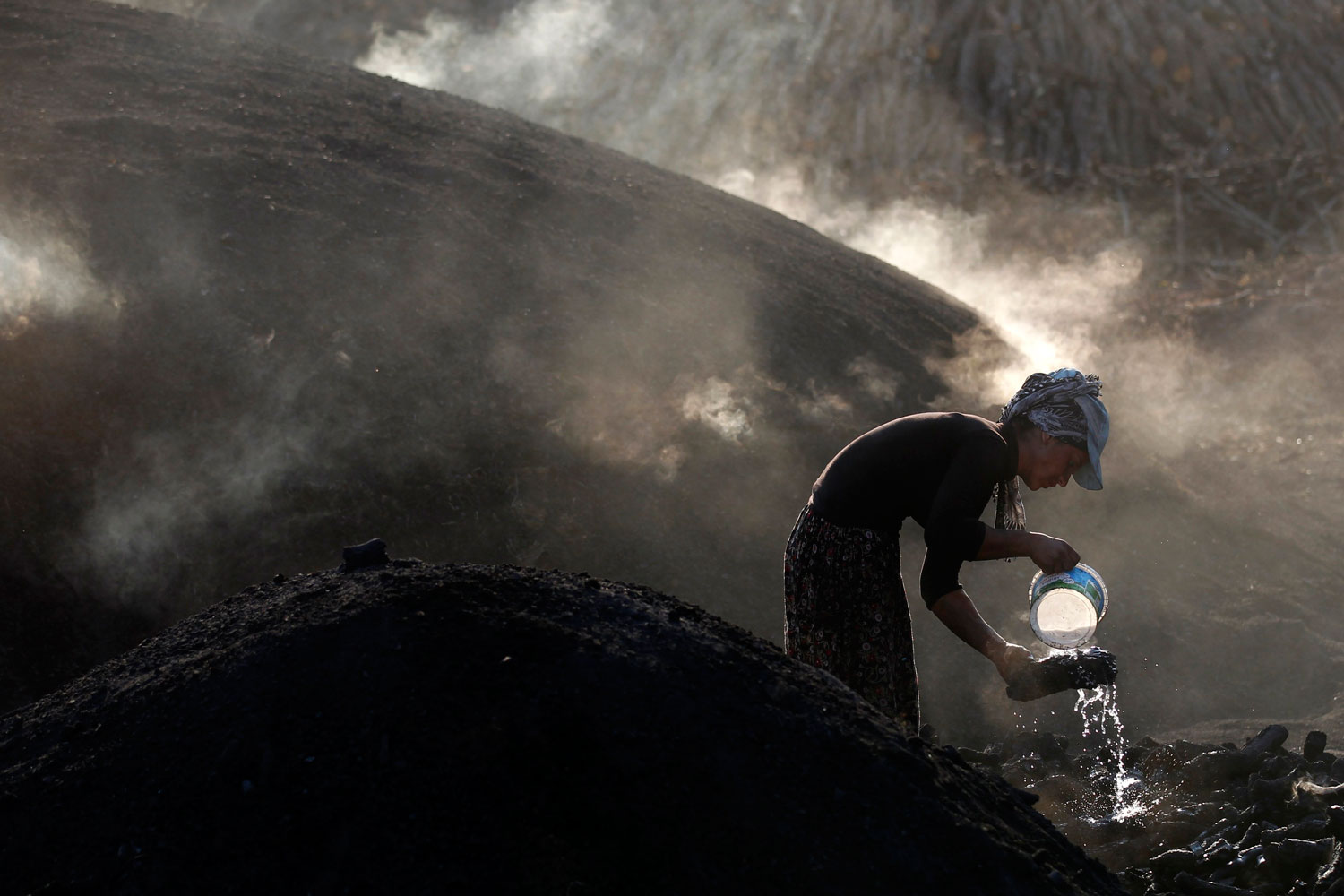 July 19, 2012. A woman makes charcoal near Kizilcahamam, a small town about 43 miles west of Turkey's capital Ankara.