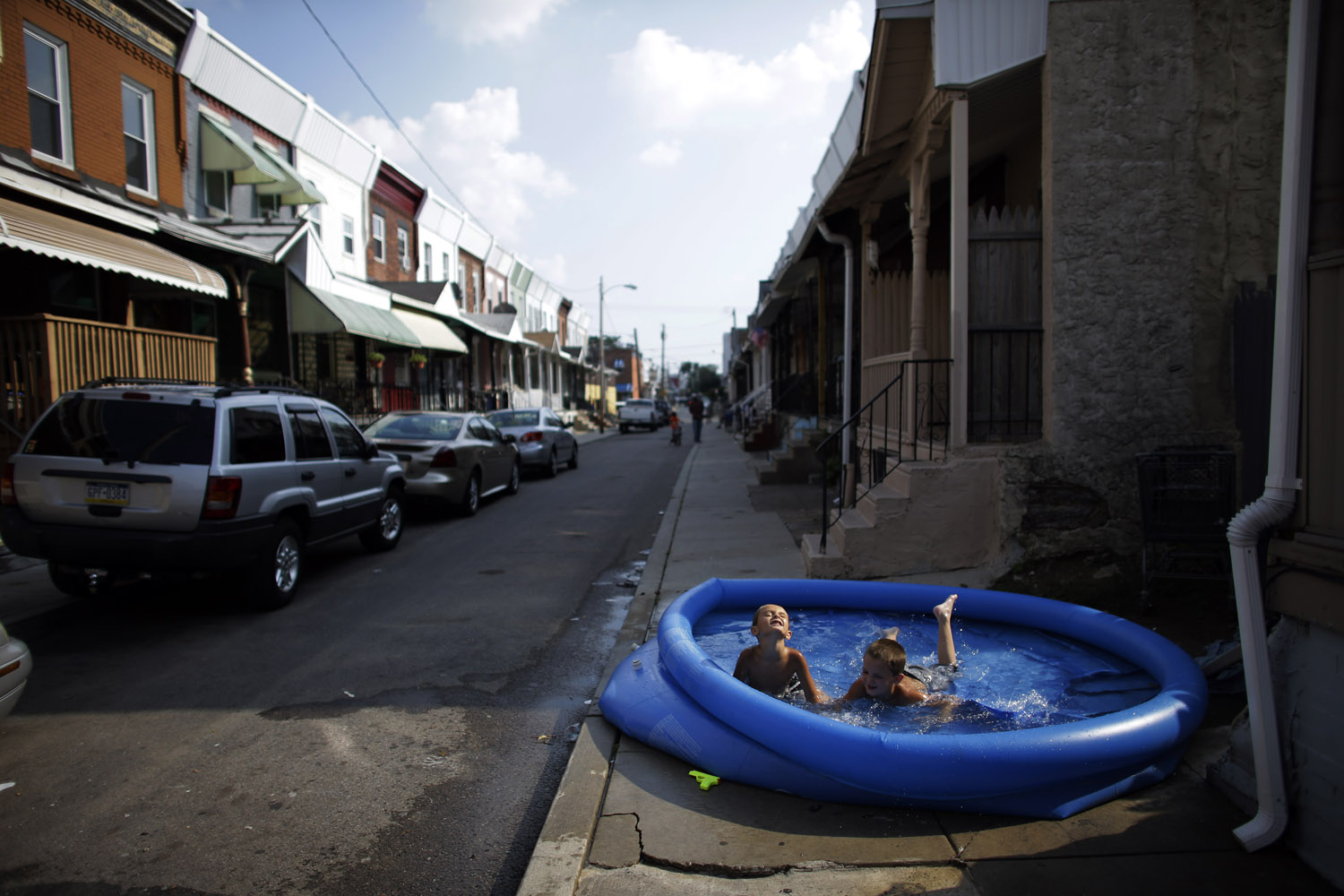 July 16, 2012. Joey Potts, left, 5, and his brother Jordan Kerver, 7, cool off in a wade pool in Philadelphia.