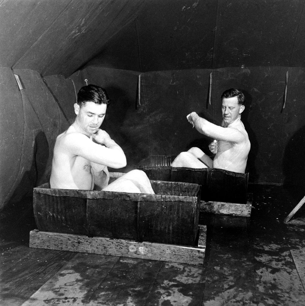 Bathing in halved oil drums, Amchitka Island, Aleutian Campaign, Alaska, 1943.