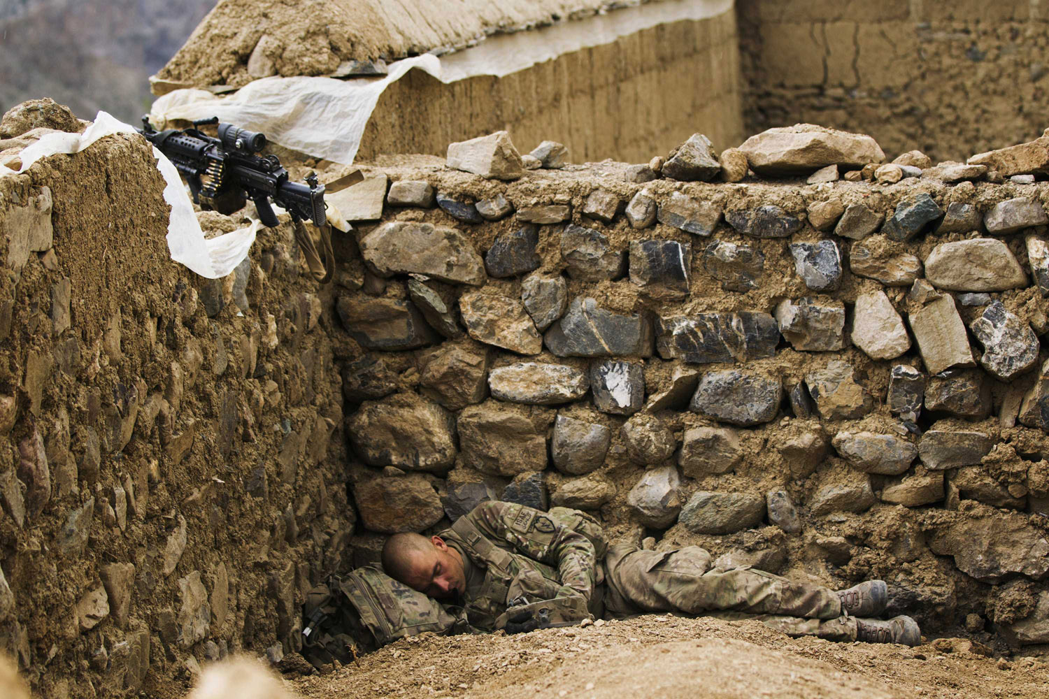 July 16, 2012. A paratrooper rests towards the end of a helicopter assault mission near the town of Ahmad Khel in Afghanistan's Paktiya Province.