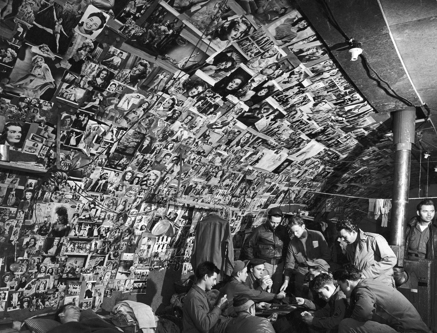 Pin-up photos adorn the walls of a bomber-crew shack on Adak Island, Aleutian Campaign, Alaska, 1943.