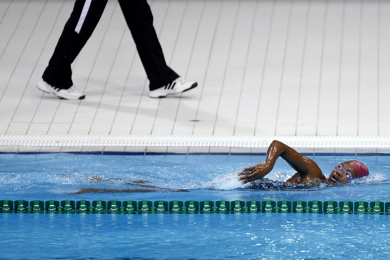 July 18, 2012. Congo's Aminata Aboubakar Yacoub, right, trains with her coach Albert Bobongo for the 2012 Summer Olympics at the Aquatics Center at the Olympic Park, in London.