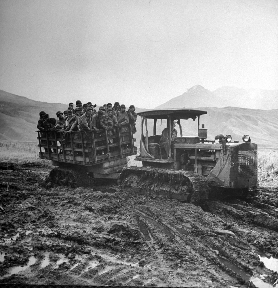 Troops are carted by tractor to the movies from an isolated camp in Massacre Vally, Attu Island, Aleutian Campaign, Alaska, 1943.
