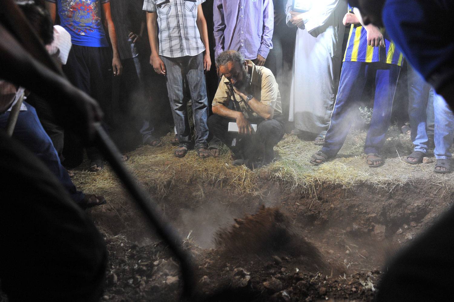 July 19, 2012. Syrians mourn during the funeral of 17-year-old Free Syrian army member Mahmud Derwish.