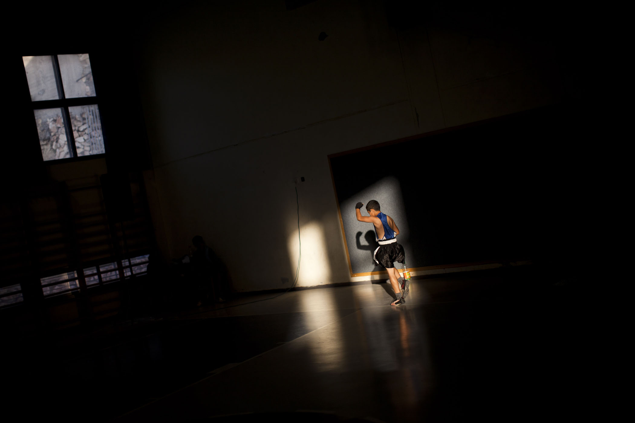 An Israeli Arab boy warms up before a fight during Israel's National Youth Boxing Championship in the Arab village of Arabe, northern Israel.