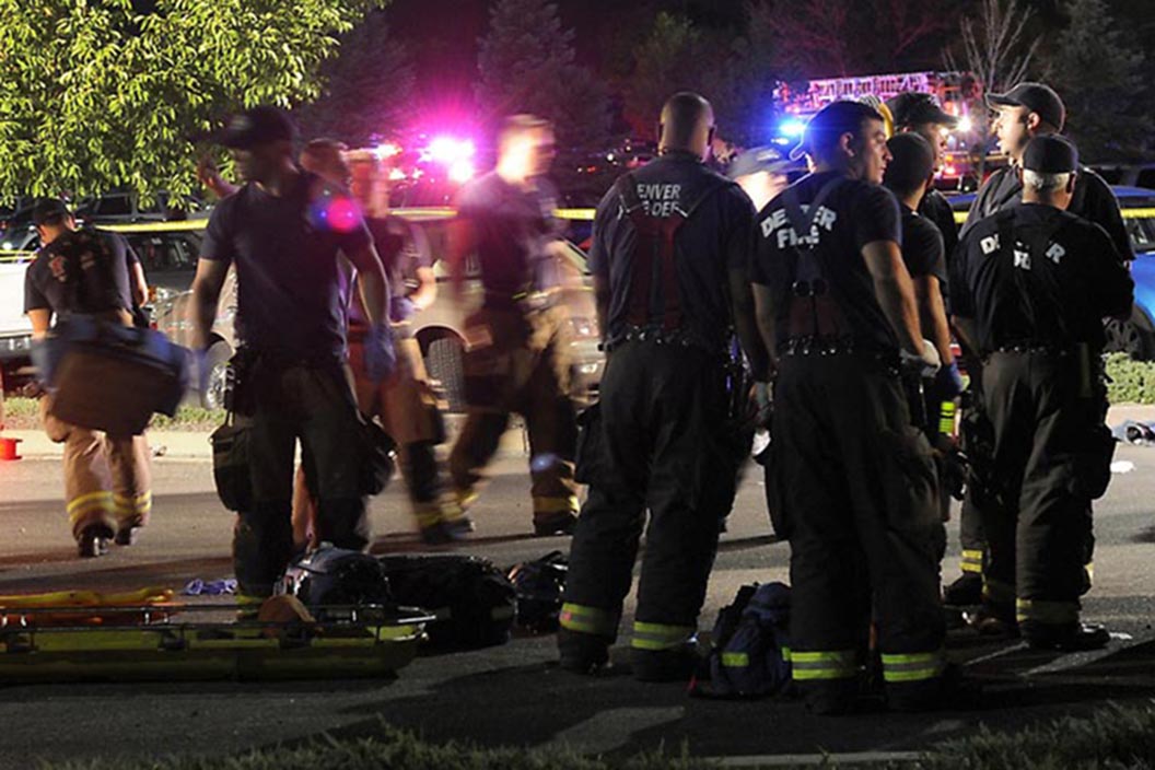 Paramedics work at the scene of the shooting where dozens of people were injured at the Century 16 movie theater in Aurora, Colo., early Friday morning July 20, 2012.