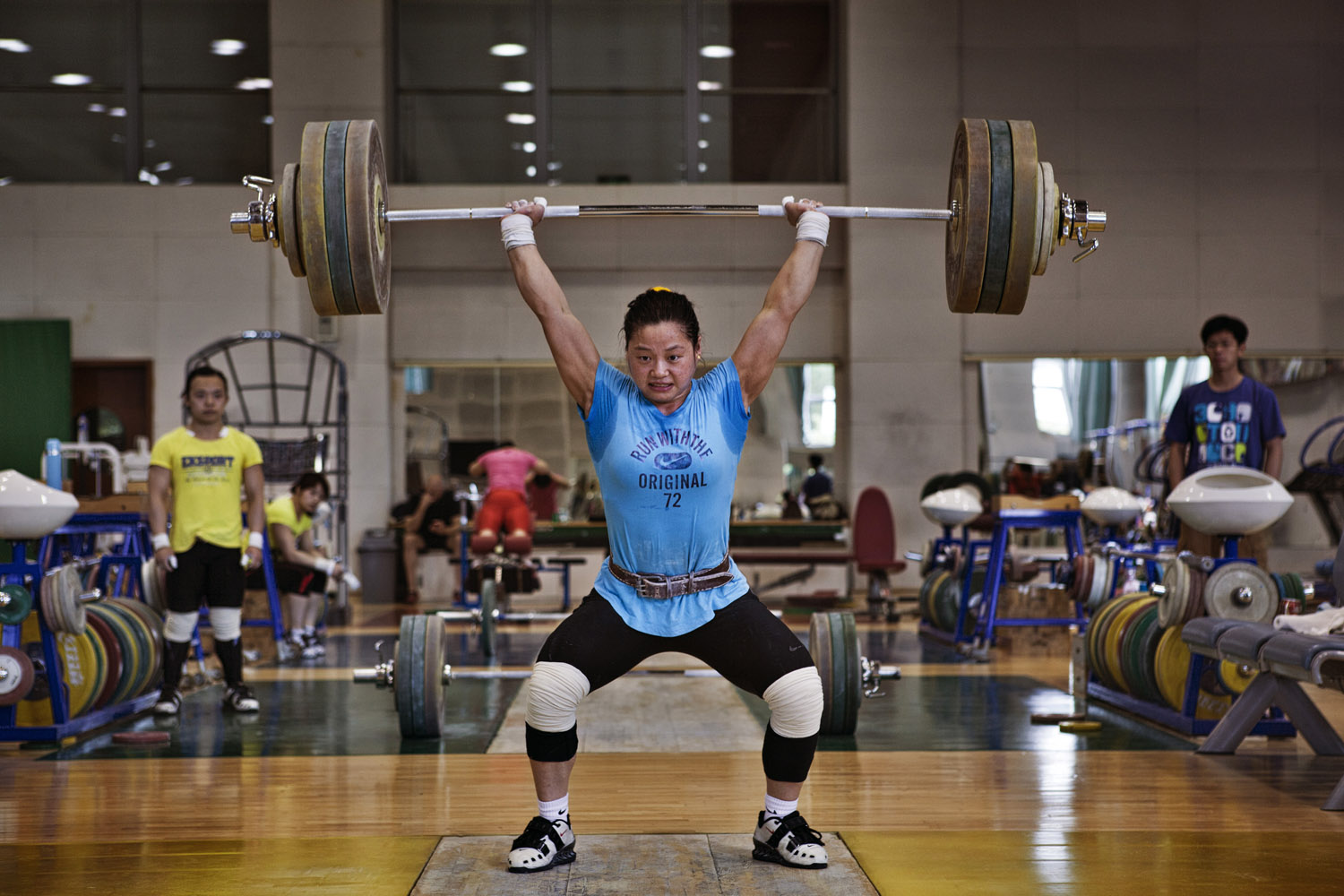 Li Xueying shows her enormous power during a successful lift while training for the Chinese women's Olympic weight-lifting team.