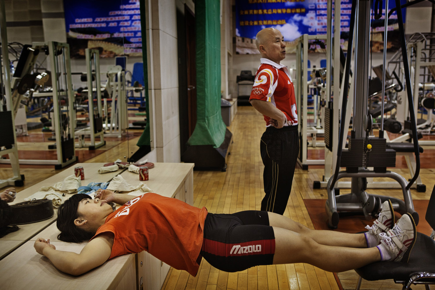 Wang Mingjuan stretches during a break while training for a place on the the Chinese women's Olympic weight-lifting team.