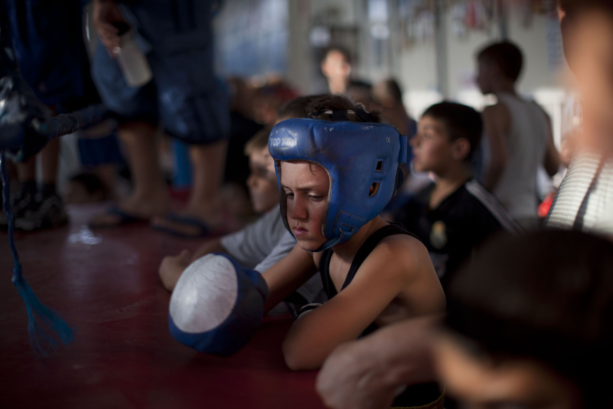 A young Israeli boxer waits for his fight during Israel's National Youth Boxing Championship in the Arab village of Kfar Yasif, northern Israel.