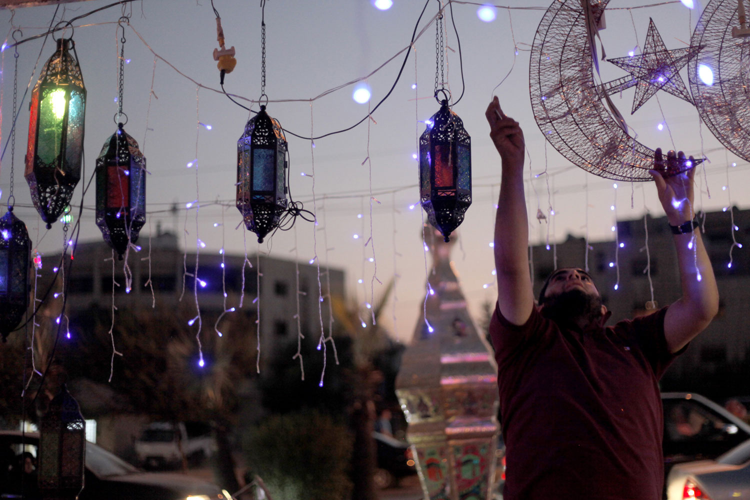 July 19, 2012. A street vendor plugs in decorations for Ramadan in Amman, Jordan.