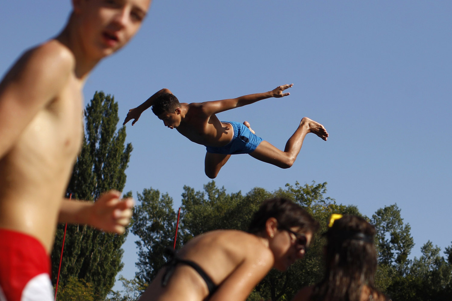 Aug. 20, 2012. A youth jumps from a diving platform at Stadionbad, a public outdoor swimming pool, in Vienna.