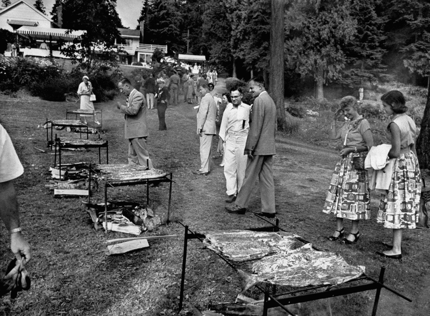 John D. Lodge (in the suit), the governor of Connecticut from 1951-55, surveys the scene at a salmon barbecue in 1953.