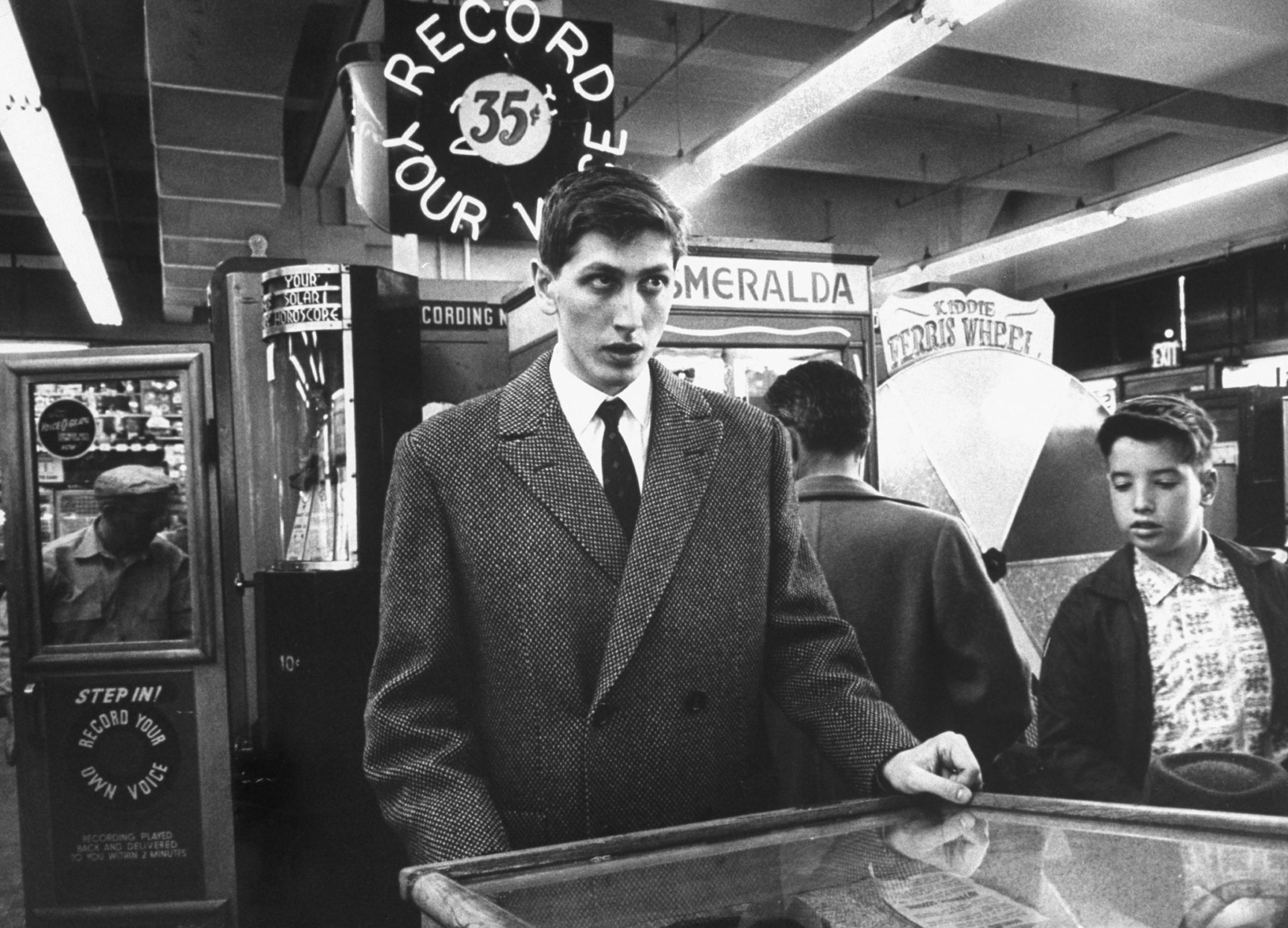 With chess problems spinning in his head by the millions, Bobby relaxes at a coin pinball machine.