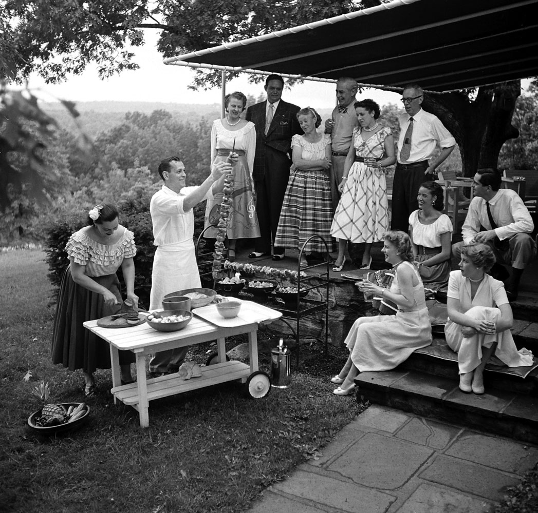 A gathering of well-dressed guests at a barbecue in Fairfield County, Conn., 1949.